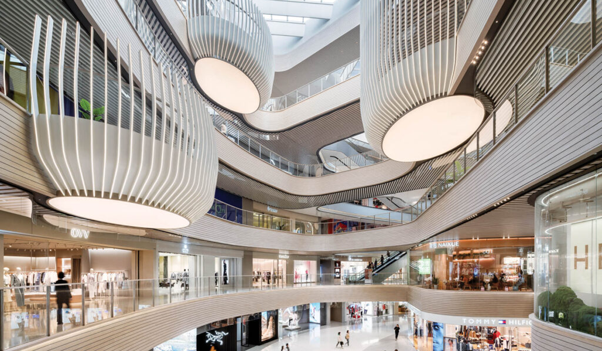 interior of shopping mall with multiple levels and sculptural lights and balcony areas