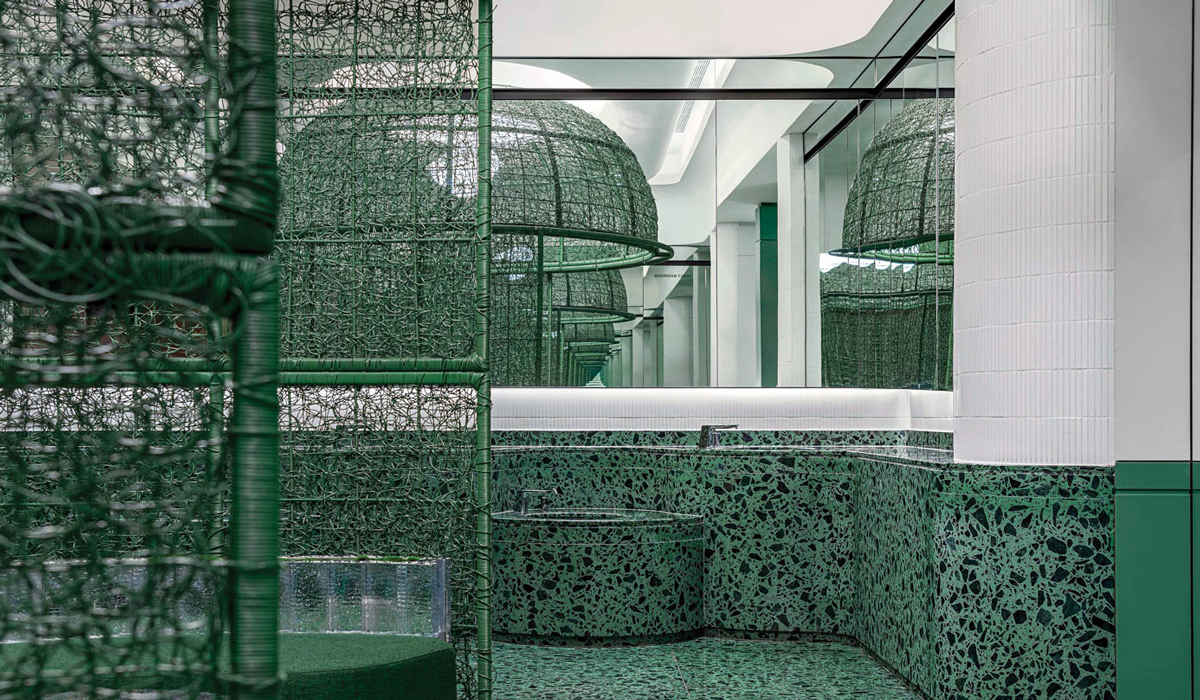 a green terrazzo gender-neutral restroom 