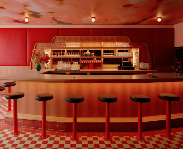the ceiling of a Brooklyn restaurant with a cloudscape mural in golds, reds, and oranges