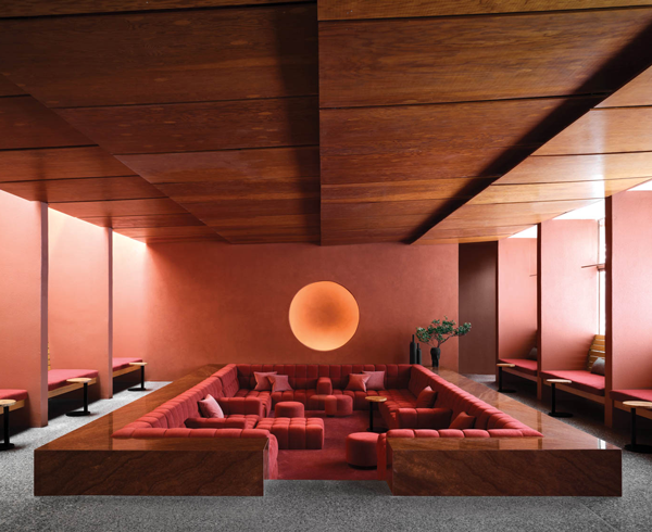 sunken seating in the living room of a resort spa in Arizona, in shades of red