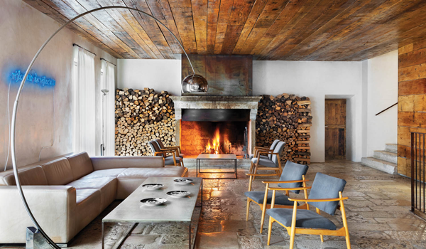 a neon sign and fireplace light up the lounge at this hotel