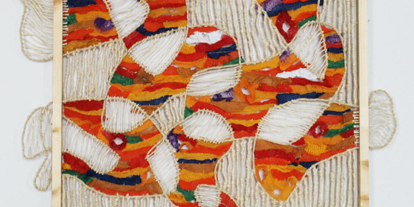 a ta[estry with deep orange, red and green hues