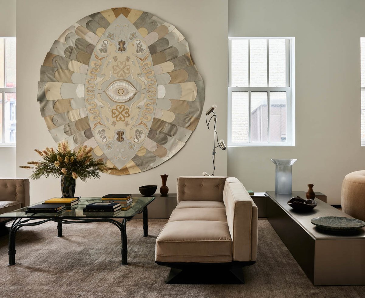 Tau Lewis' Tree of God (2021) hangs on the wall of a main lounge in an office