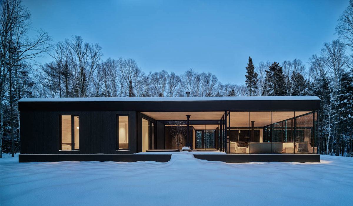 a glass house among the snow