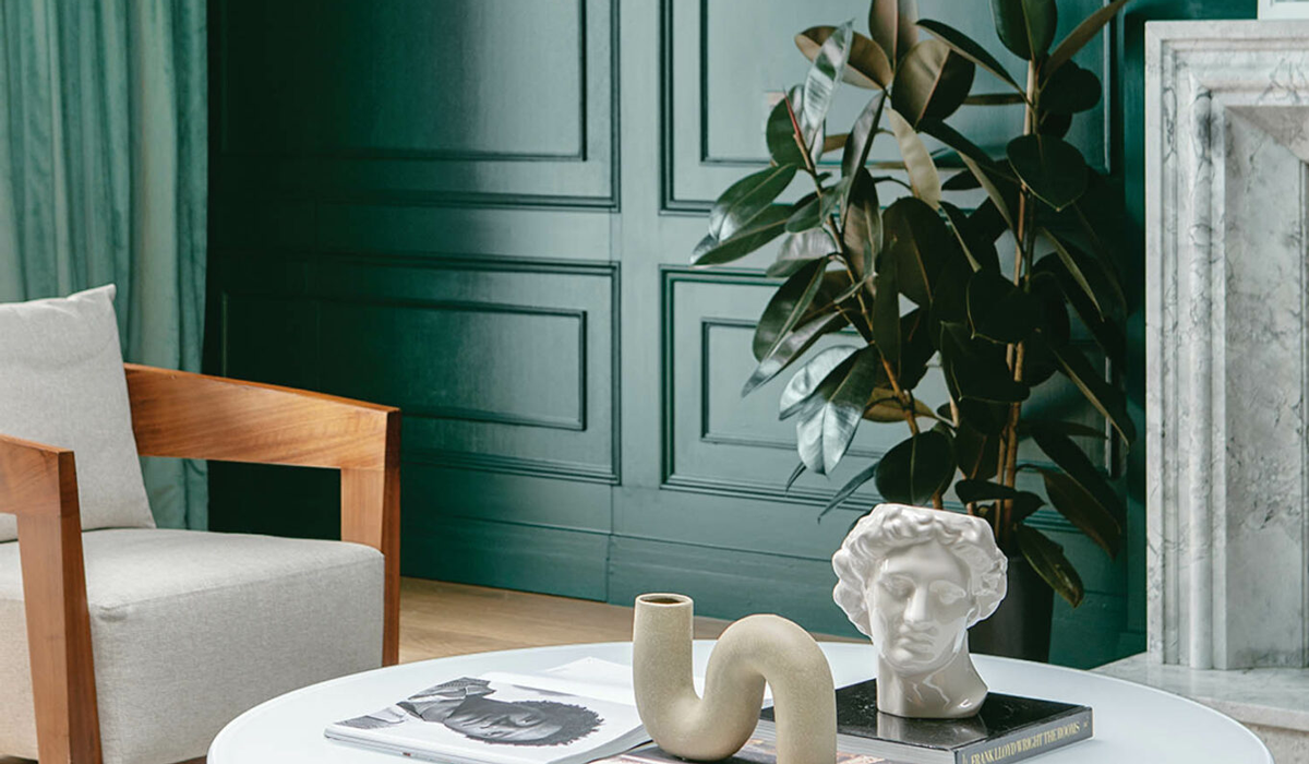 a green walled living room with modern accents