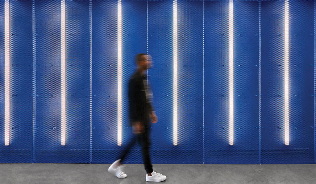 a blue wall with vertical LED lights