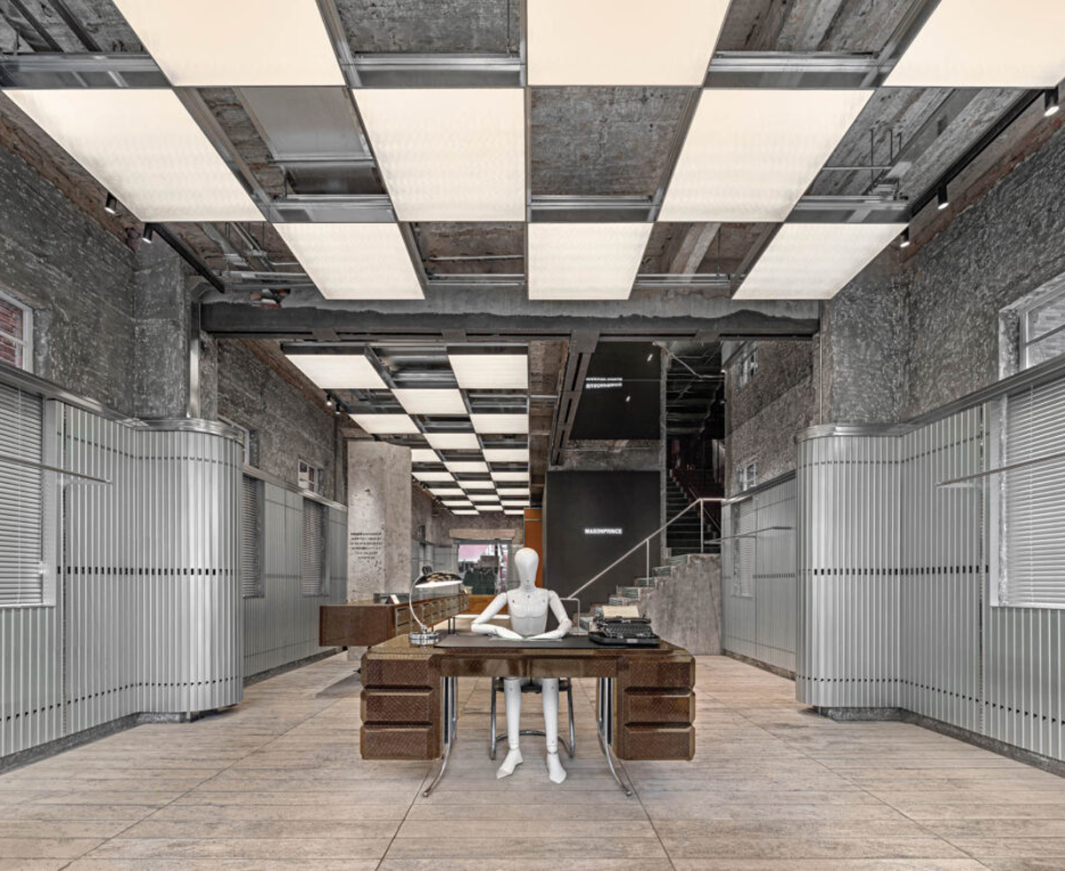 A mannequin sitting at a wooden desk