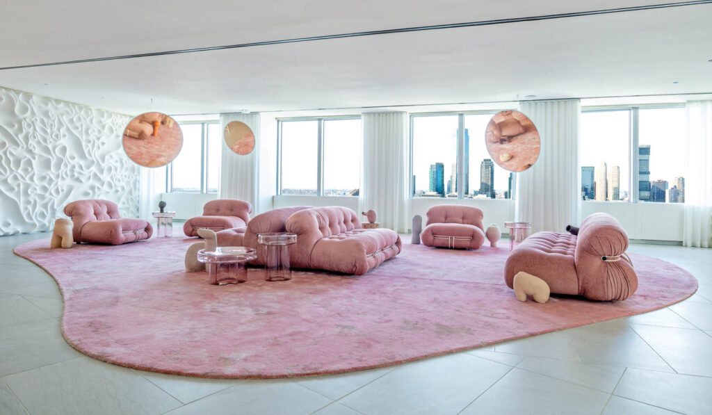 an office area with pink furniture and a pink rug