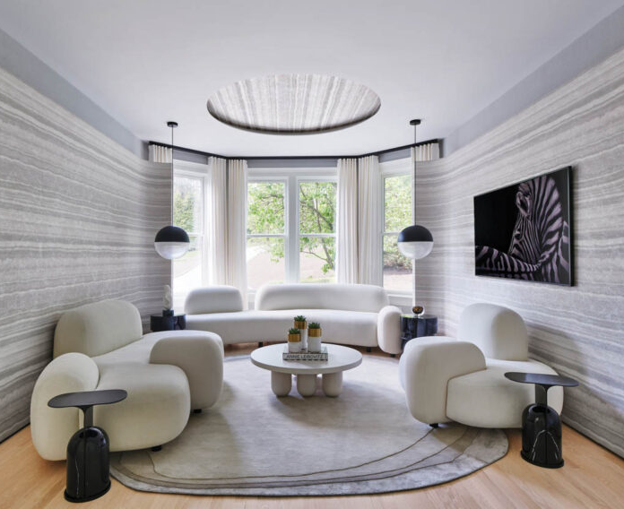 a living room with white furnishings and gray walls