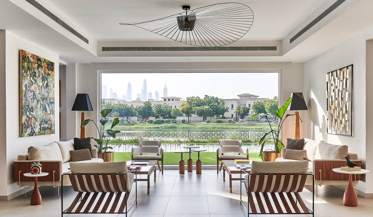 an open-air living area in a Dubai villa looking out to a lake