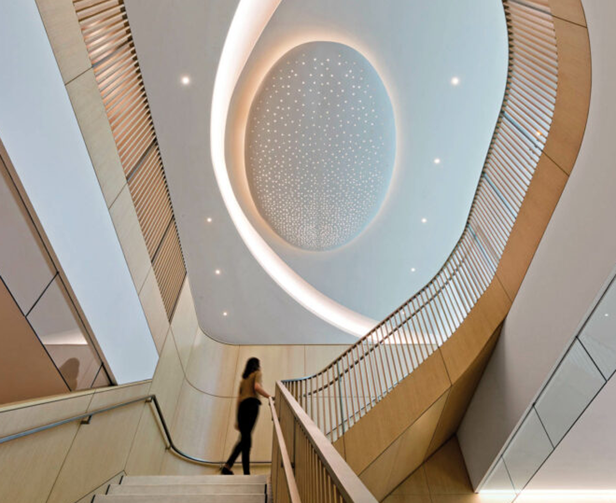 a woman climbs a winding staircase in blackrock's hq