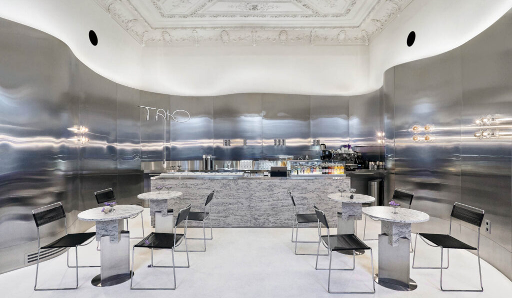 a gray interior with black stools inside Tanu Gelaterie in Ukraine