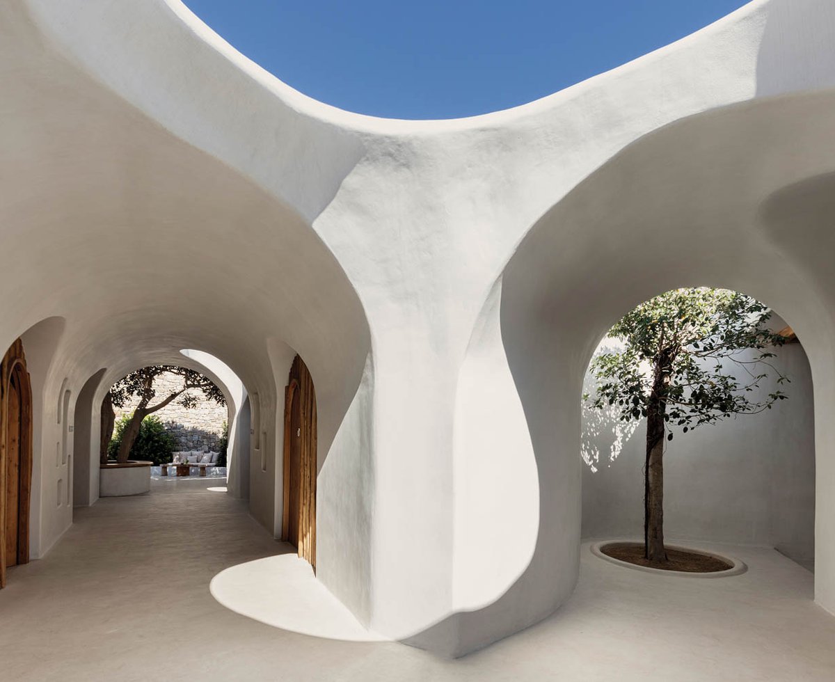 white stone walls form the exterior hallways of Super Paradise Beach Club
