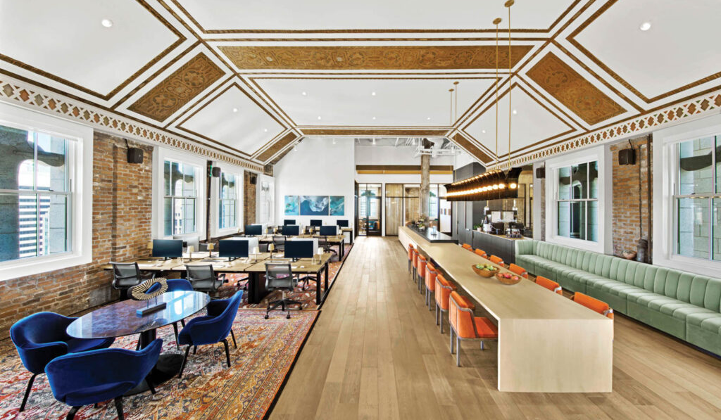 dining room lobby with midnight blue armchairs on one side and dining area on another