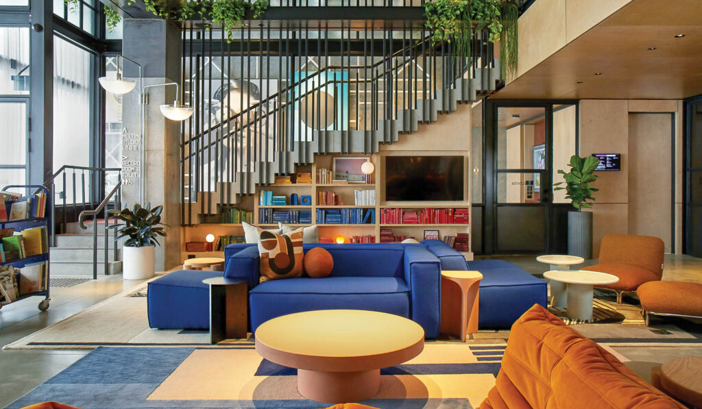 sitting room with bright blue seating area and orange gaming chairs