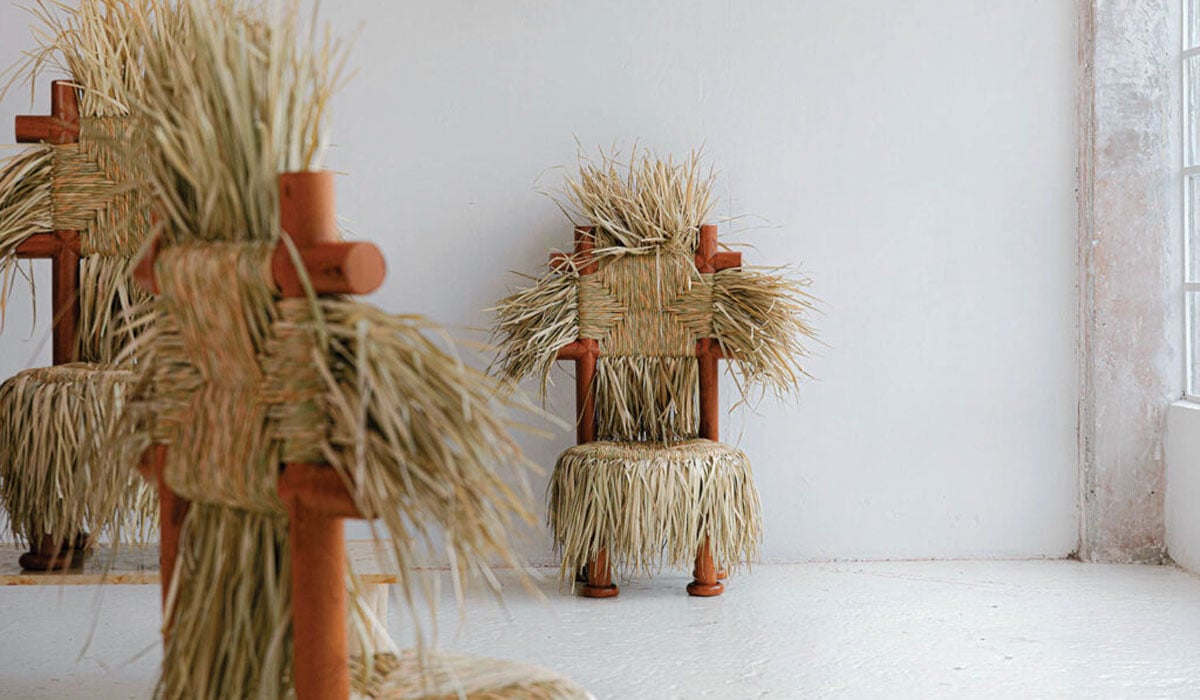 a whimsical chair with a woven straw backing and seat