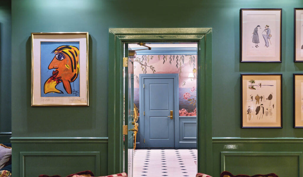 dark green room with artwork on walls