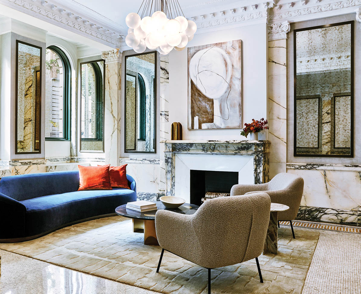 living room with marble walls, fireplace and furnishings and dark blue sofa