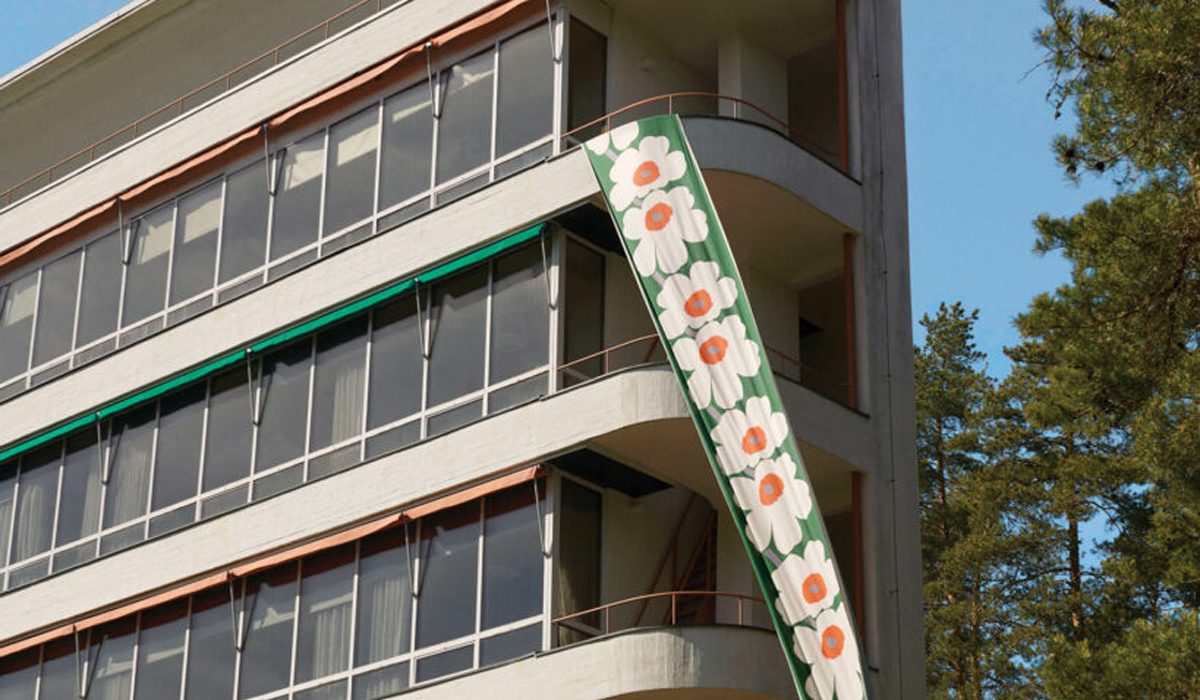 outside of office building with green banner and white poppy