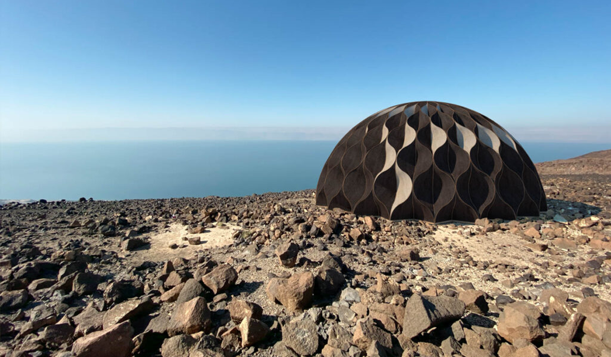 biome dome made of wood on a rocky coast