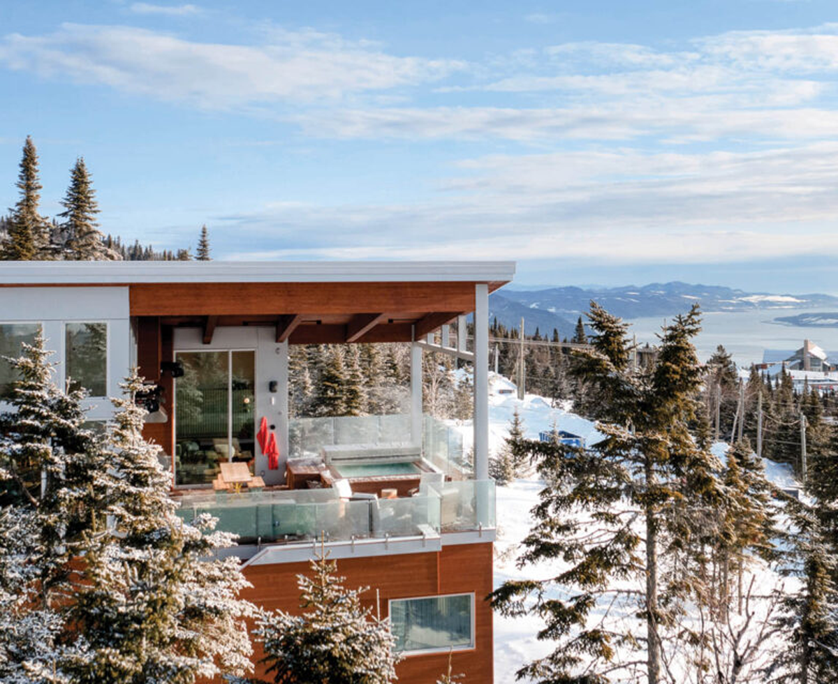 exterior facade of ski chalet surrounding by the snowy mountains