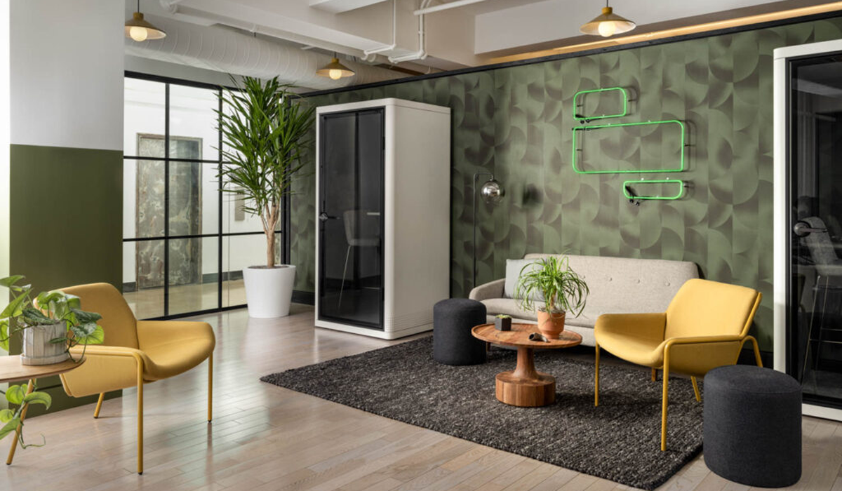 green themed office space with podcast booth and sofas