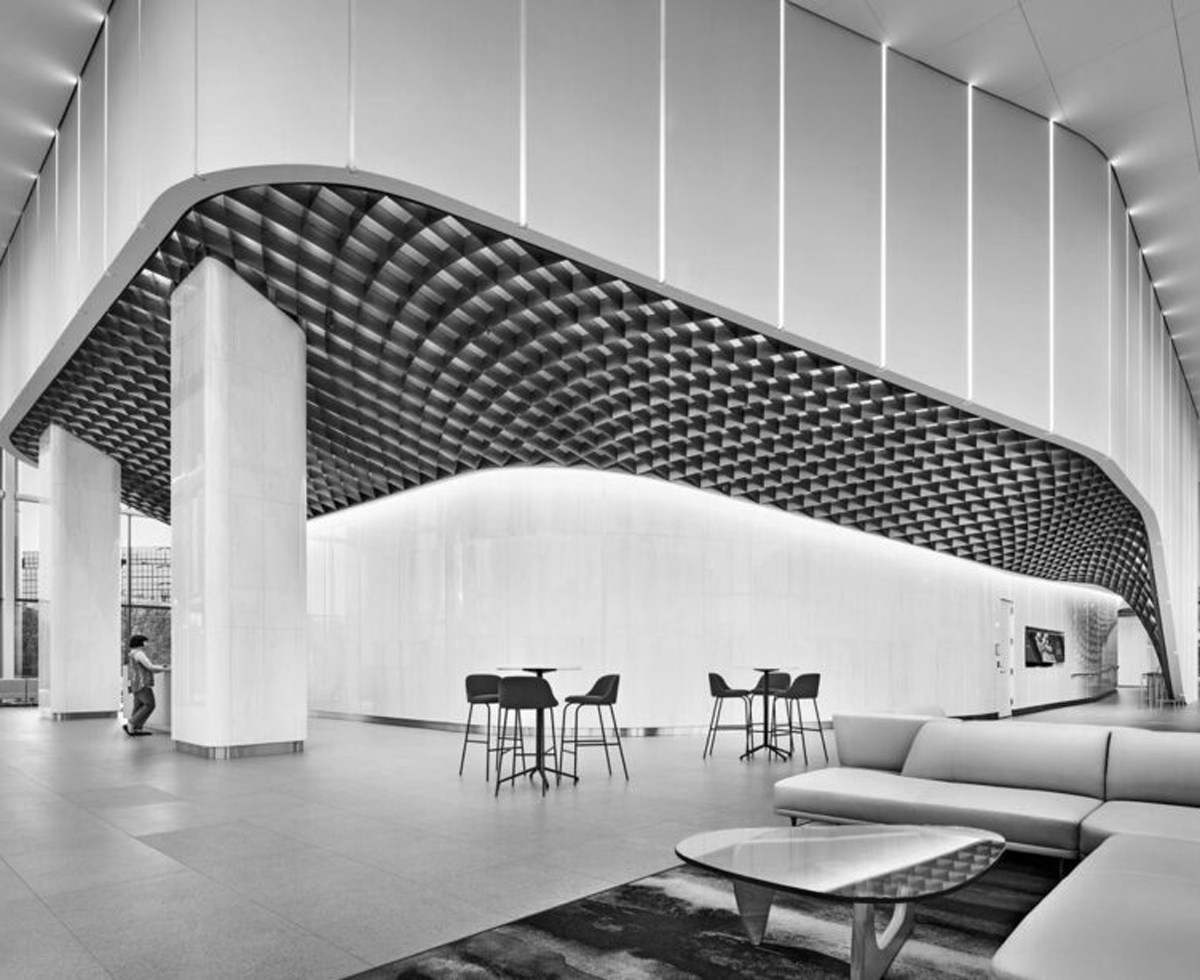 communal area with lots of seating, bright lights and arched entryway