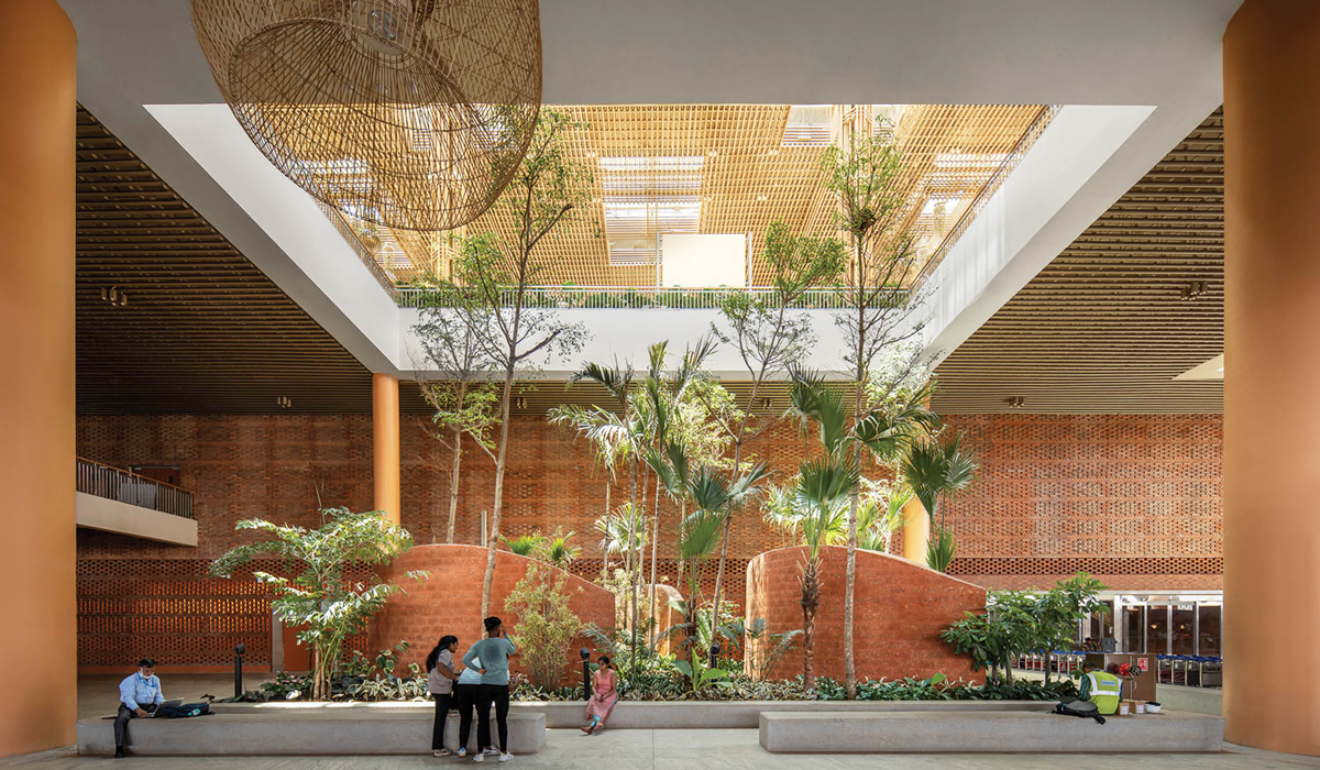 airport terminal garden with lots of greenery, orange reddish bases and lots of light