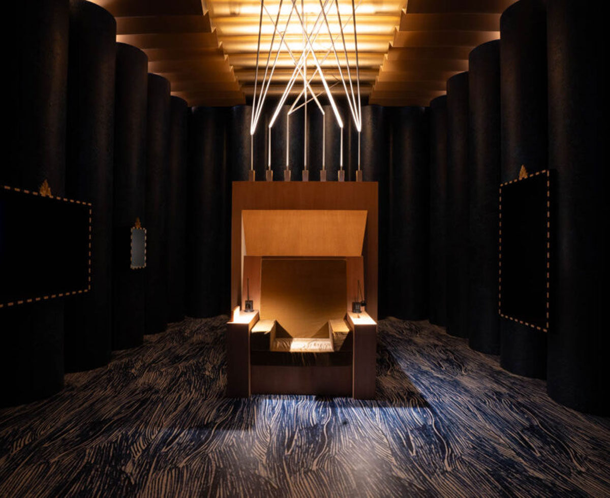A throne-like chair under spotlight