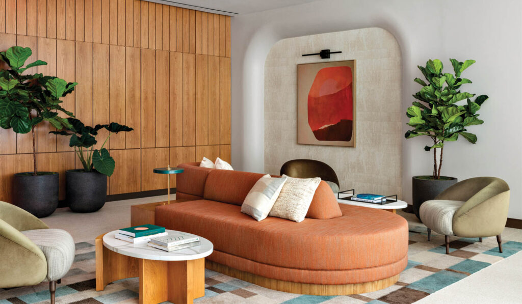 living room with orange seating area and wooden paneled wall