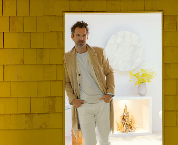 Mathieu Lehanneur standing in a yellow doorway