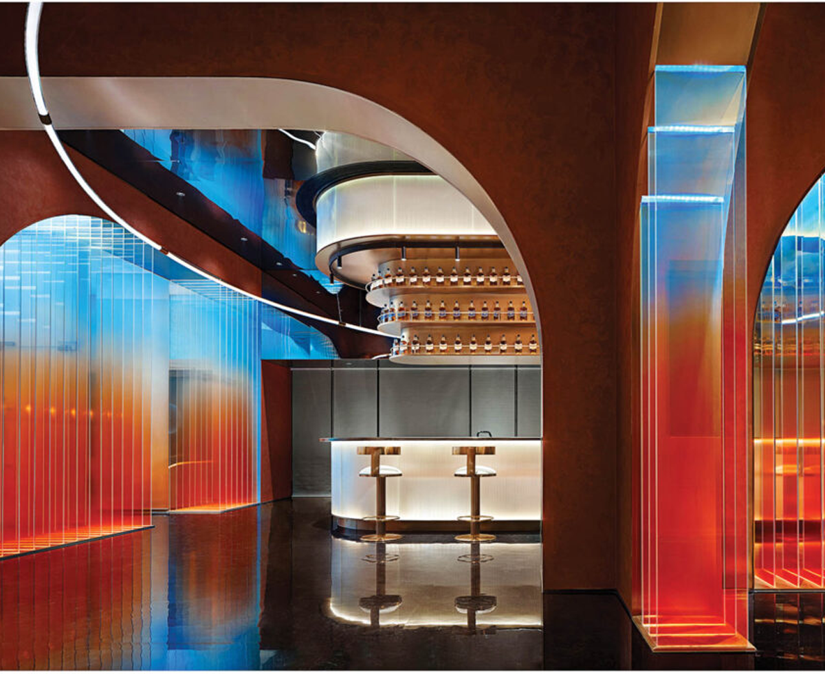 interior of a bar with gradient orange and blue panels and white bar tops