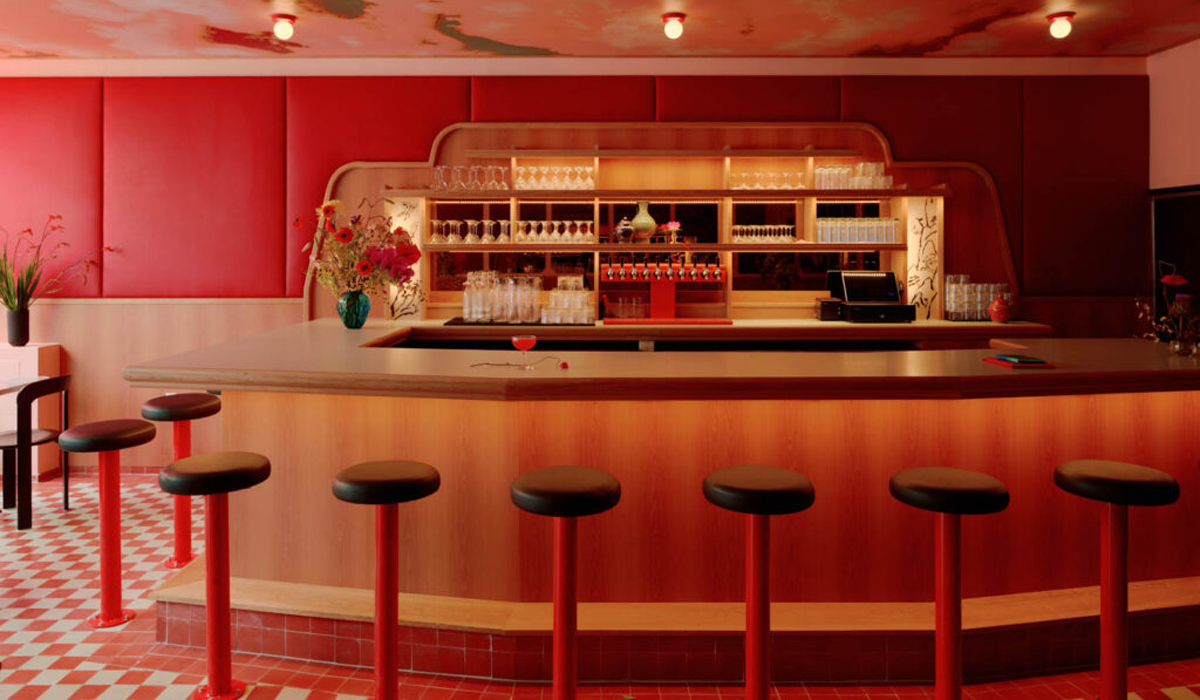 bar with red wall panels and chic retro style lighting and bar stools