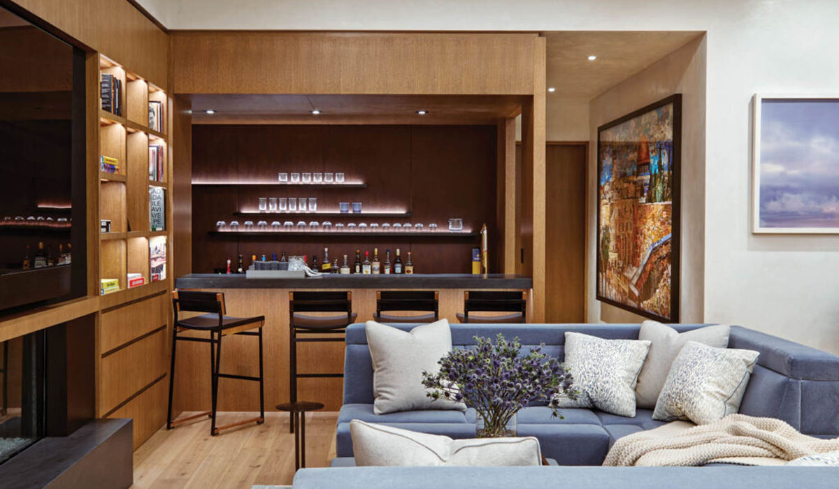living room home bar with wooden accents and black stools