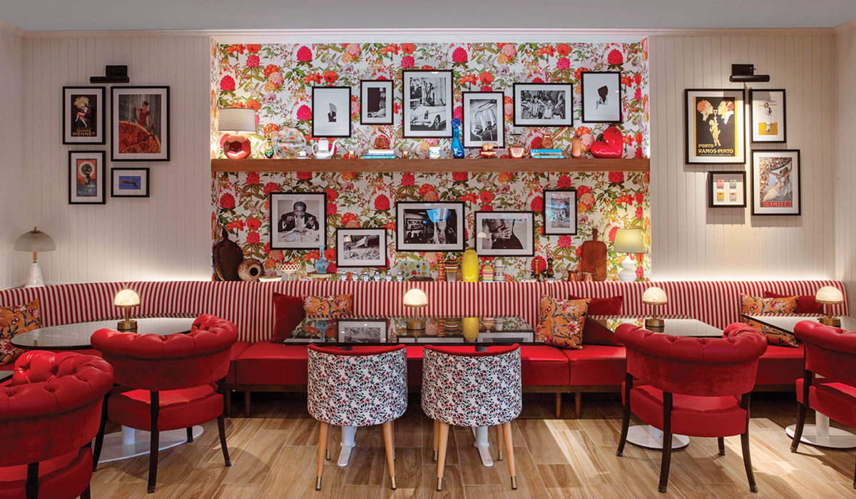 a restaurants with red velvet chairs and pops of color