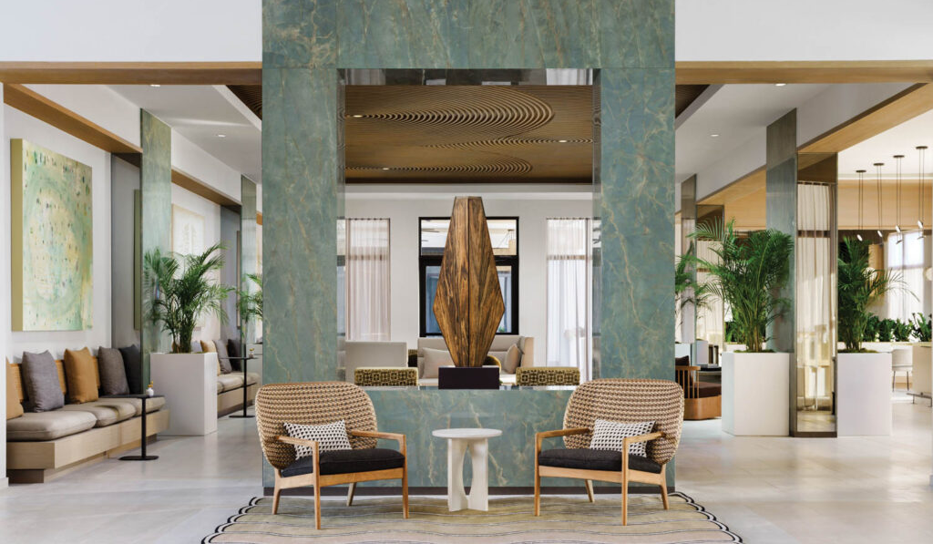 corner of lobby with aqua blue structure and fountain in the middle