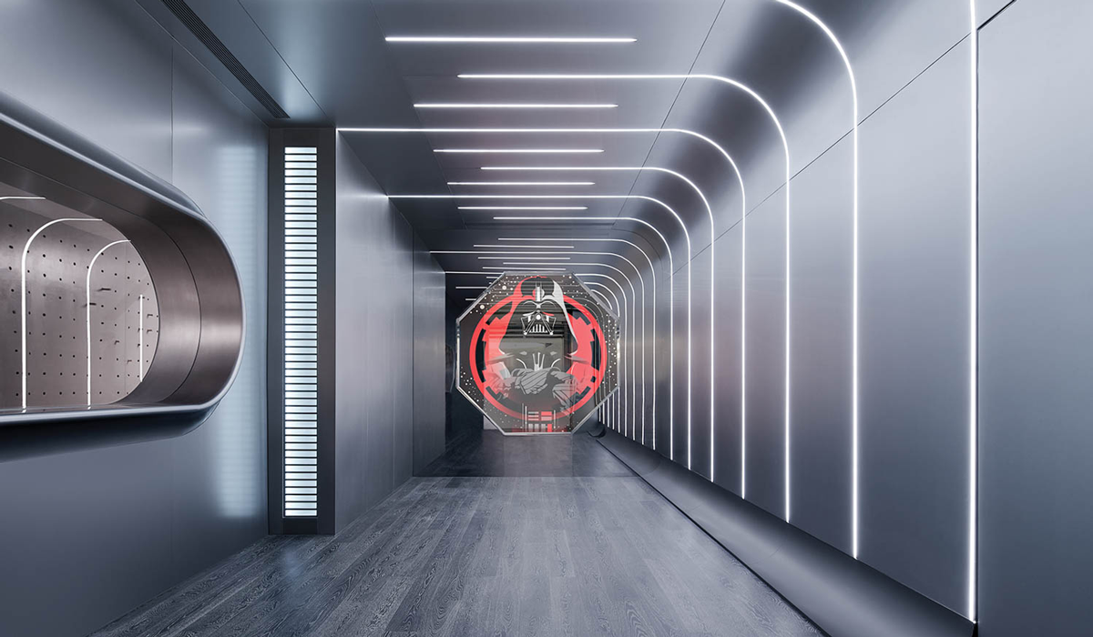 all aluminum based room with curved fluorescent lights and large Darth Vader light by the door