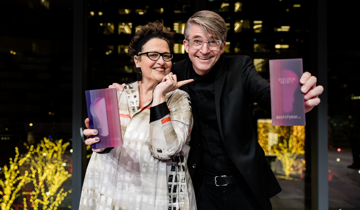 Cindy Allen holding trophies with another person in glasses