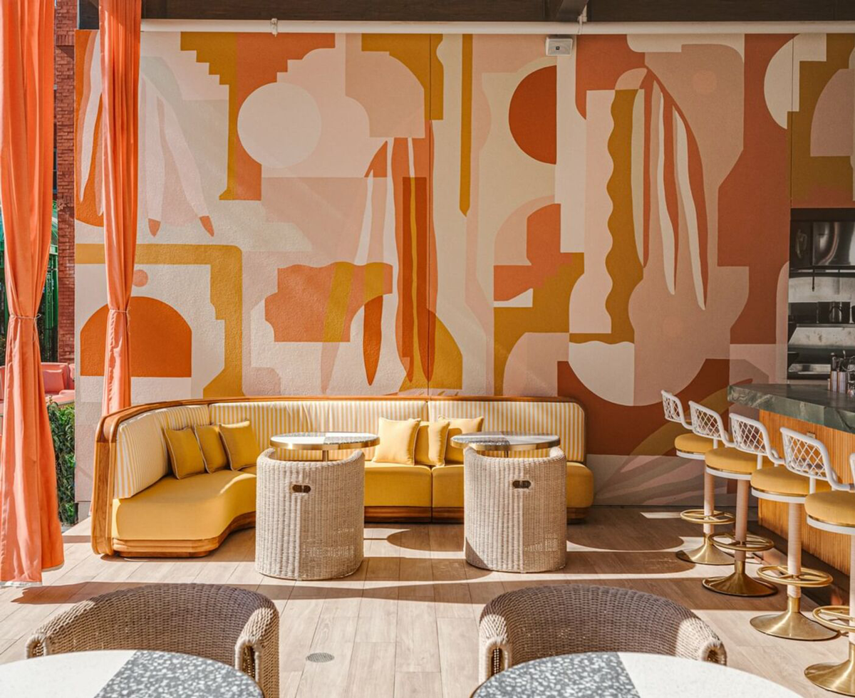 room with bright orange drapes, orange backdrop and seating next to kitchen countertop