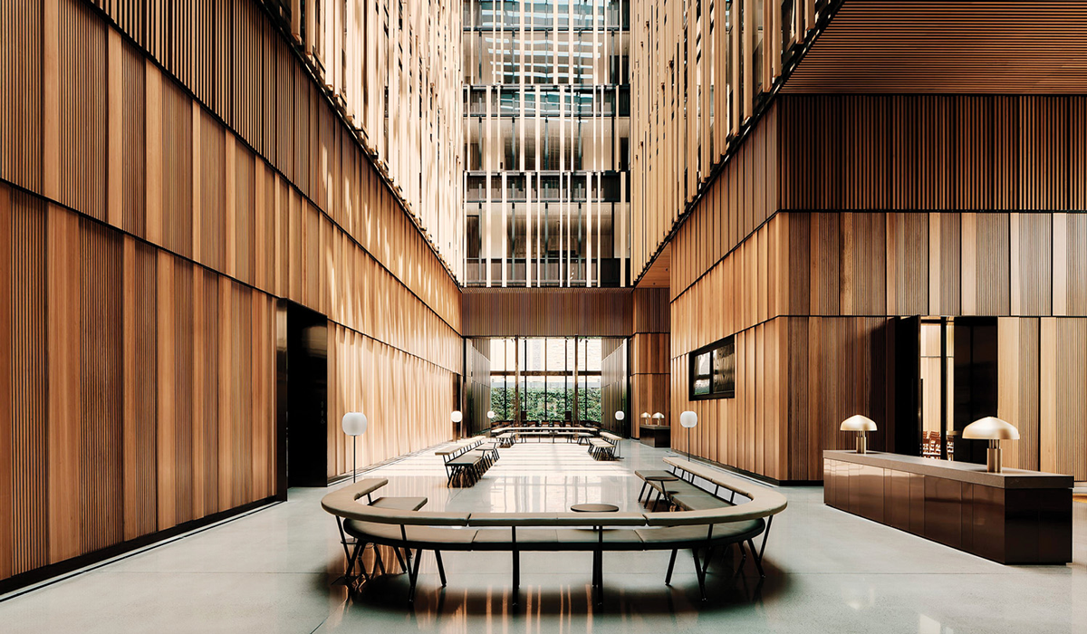 hallway space with wooden slatted walls, circular seating area and lots of light