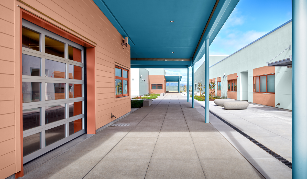 outdoor courtyard with coral walls and blue roof