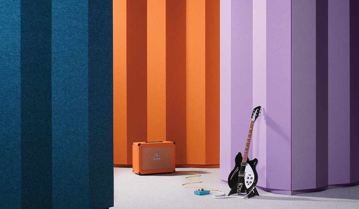 turf acoustics with guitar leaning on wall