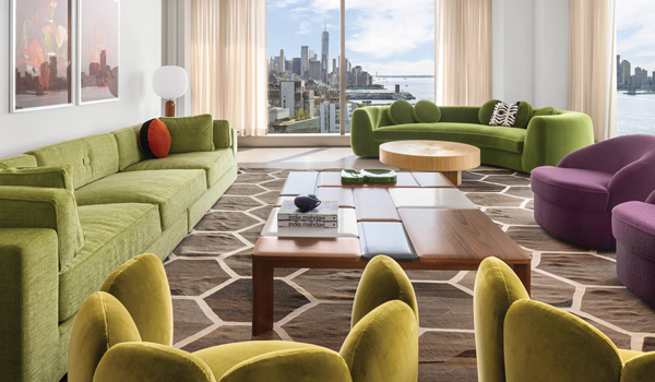 couches in shades of green and purple in the living room of an apartment