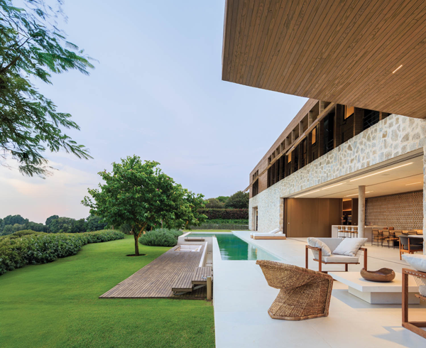 an outdoor patio with a pool off of a six-bedroom house