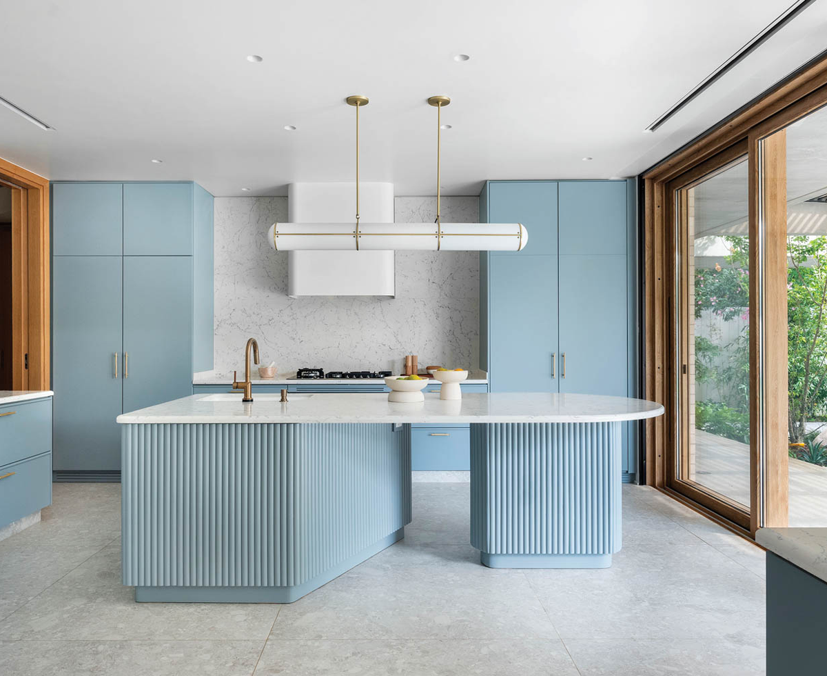 a kitchen with blue cabinetry