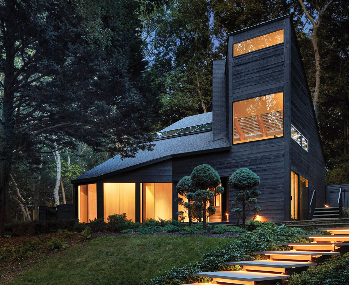 the exterior of a black house lit up at night