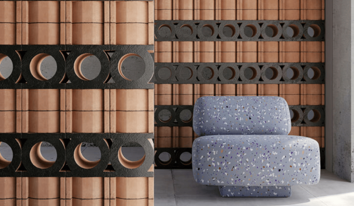 brown tiles with black circular cutouts behind grey chair with speckles