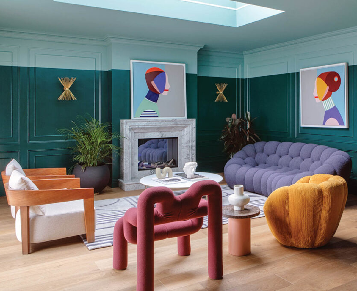 dark teal room with eclectic furnishings and abstract art