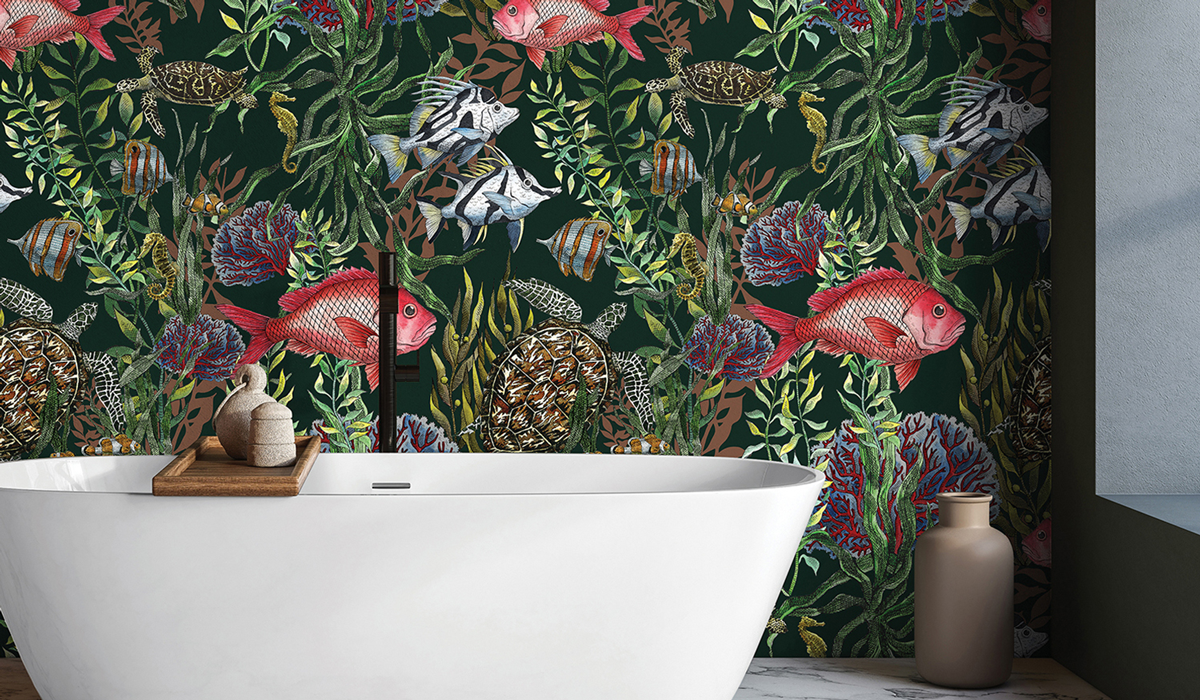 a white bathtub with wallcoverings of fish and sea greens