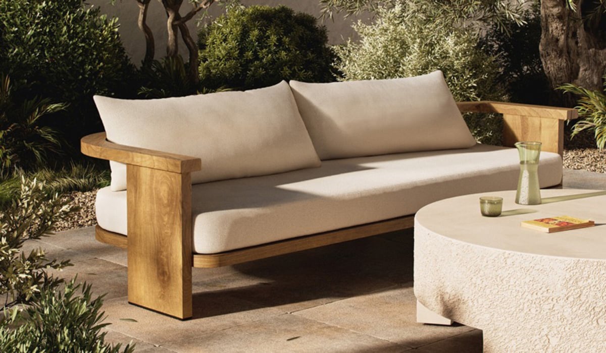 An upholstered sofa with wooden base.